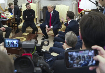 Vice President JD Vance, right, speaks with Ukrainian President Volodymyr Zelenskyy, left, as President Donald Trump, center, listens in the Oval Office at the White House, Friday, Feb. 28, 2025, in Washington. (AP Photo/ Mystyslav Chernov)