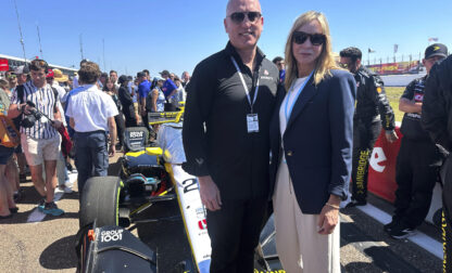 Dan Towriss, the new owner of Andretti Global, and Jill Gregory, president of Andretti Global, stand in front of Colton Herta's race car before the season-opening race, Sunday, March 2, 2025, in St. Petersburg, Fla. (AP Photo/Jenna Fryer)