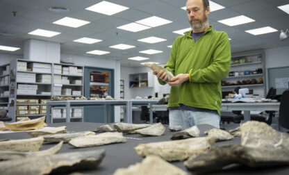 In this photo provided by the Spanish National Research Council (CSIC), researcher Ignacio de la Torre holds a bone tool found in Tanzania's Olduvai Gorge, at the CSIC-Pleistocene Archaeology Lab in Madrid in 2023. (Angeliki Theodoropoulou/CSIC via AP)