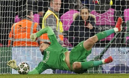 PSG's goalkeeper Gianluigi Donnarumma saves a penalty from Liverpool's Curtis Jones during a shootout at the end of the Champions League round of 16 second leg soccer match between Liverpool and Paris Saint-Germain at Anfield in Liverpool, England, Tuesday, March 11, 2025. (AP Photo/Dave Thompson)