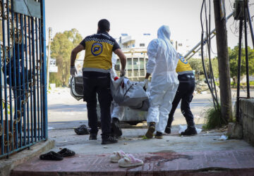 In this photo provided by the Syrian Civil Defense White Helmets, members of the Syrian White Helmets collect the bodies of people found dead following a recent wave of violence between Syrian security forces and gunmen loyal to former President Bashar Assad, as well as subsequent sectarian attacks, in the coastal city of Baniyas, Syria, Sunday, March 9, 2025. (Syrian Civil Defense White Helmets via AP)