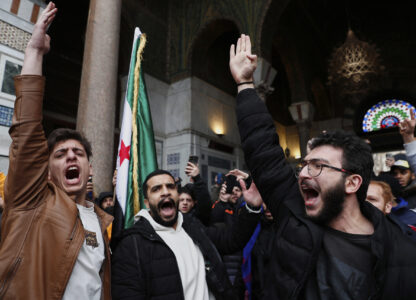 Syrian government supporters shout slogans to show their solidarity with the security forces who are fighting against gunmen loyal to former President Bashar Assad during a protest in Damascus, Syria, Friday, March 7, 2025. (AP Photo/Omar Sanadiki)