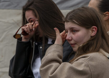 Women cry and wait in line to write condolence messages for the victims of a massive nightclub fire in the town of Kocani, North Macedonia, Monday, March 17, 2025. (AP Photo/Visar Kryeziu)