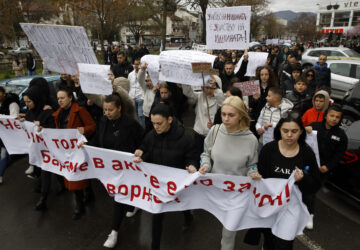 Protesters hold placards as they march during protest following a massive nightclub fire in the town of Kocani, North Macedonia, Monday, March 17, 2025. (AP Photo/Boris Grdanoski)