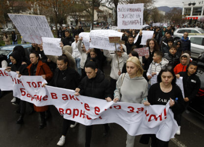 Protesters hold placards as they march during protest following a massive nightclub fire in the town of Kocani, North Macedonia, Monday, March 17, 2025. (AP Photo/Boris Grdanoski)