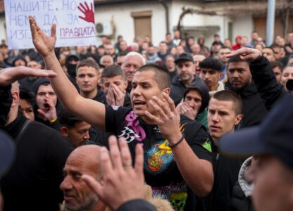 People argue with policemen, outside the home of the owner of a nightclub that was the scene of a massive fire, after a vigil for the victims in the town of Kocani, North Macedonia, Monday, March 17, 2025. (AP Photo/Armin Durgut)