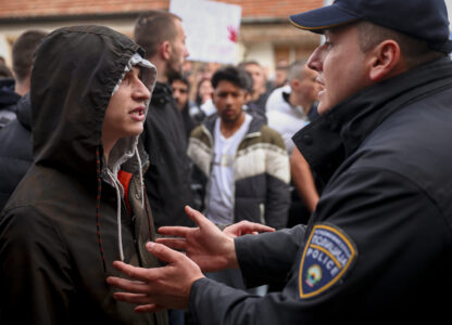 People argue with policemen, outside the home of the owner of a nightclub that was the scene of a massive fire, after a vigil for the victims in the town of Kocani, North Macedonia, Monday, March 17, 2025. (AP Photo/Armin Durgut)