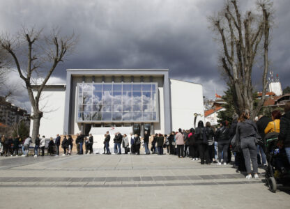 People wait in line to write condolence messages for the victims of a massive nightclub fire in the town of Kocani, North Macedonia, Monday, March 17, 2025. (AP Photo/Boris Grdanoski)