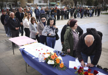 People wait in line to write condolence messages for the victims of a massive nightclub fire in the town of Kocani, North Macedonia, Monday, March 17, 2025, (AP Photo/Armin Durgut)