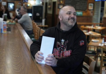 Terence Haggerty talks to customers in his family bar, Jody's Club Forest, in Staten Island, New York, Monday, March 10, 2025. (AP Photo/Seth Wenig)