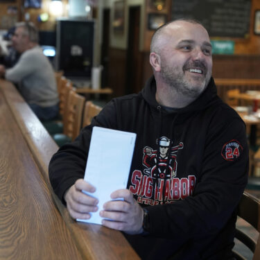 Terence Haggerty talks to customers in his family bar, Jody's Club Forest, in Staten Island, New York, Monday, March 10, 2025. (AP Photo/Seth Wenig)