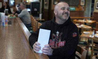 Terence Haggerty talks to customers in his family bar, Jody's Club Forest, in Staten Island, New York, Monday, March 10, 2025. (AP Photo/Seth Wenig)