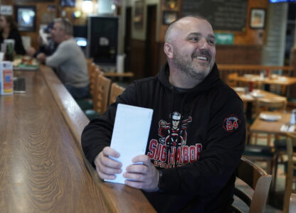 Terence Haggerty talks to customers in his family bar, Jody's Club Forest, in Staten Island, New York, Monday, March 10, 2025. (AP Photo/Seth Wenig)