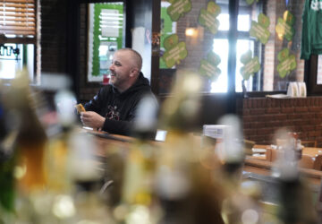 Terence Haggerty grabs a quick lunch at his family bar, Jody's Club Forest, in Staten Island, New York, Monday, March 10, 2025. (AP Photo/Seth Wenig)