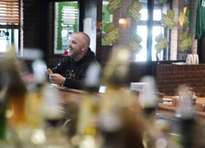 Terence Haggerty grabs a quick lunch at his family bar, Jody's Club Forest, in Staten Island, New York, Monday, March 10, 2025. (AP Photo/Seth Wenig)