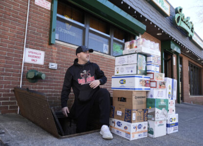 Terence Haggerty loads supplies into the basement of his bar, Jody's Club Forest, in Staten Island, New York, Monday, March 10, 2025. (AP Photo/Seth Wenig)