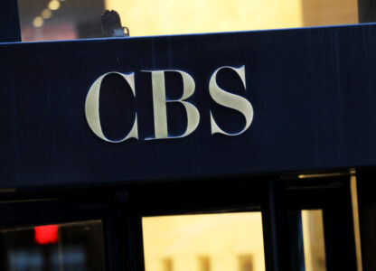 FILE - The CBS logo at the entrance to its headquarters, in New York Dec. 6, 2018. (AP Photo/Mark Lennihan, File)