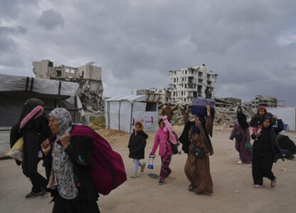 Displaced Palestinians, carrying their belongings, move away from the areas where the Israeli army is operating after Israel's renewed offensive in the Gaza Strip, on the outskirts of Beit Lahia, Thursday, March 20, 2025. (AP Photo/Jehad Alshrafi)