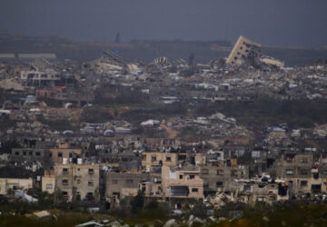 Buildings destroyed during the Israeli air and ground offensive in the Gaza Strip as seen from southern Israel, Thursday, March 20, 2025. (AP Photo/Leo Correa)