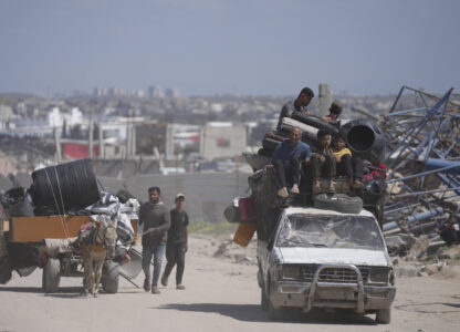 Displaced Palestinians, carrying their belongings traveling from Beit Hanoun to Jabaliya, a day after Israel's renewed offensive in the Gaza Strip, Wednesday, March 19, 2025. (AP Photo/Jehad Alshrafi)